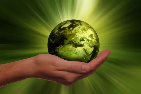 Human hand holding symbolic earth as a sign of sustainability