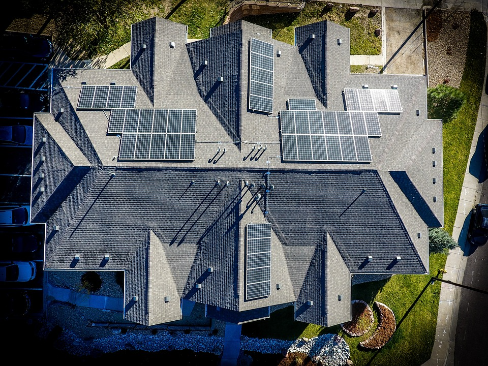 Solar panels on the roof of a house symbolized as sustainable energy. 